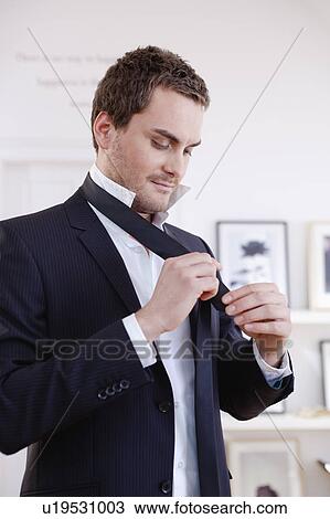 man tying a tie View Large Photo Image Stock Image - man tying a tie. Fotosearch