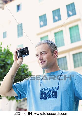man using camera View Large Photo Image Picture - man using camera. Fotosearch