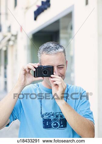 Stock Image - man using camera. Fotosearch