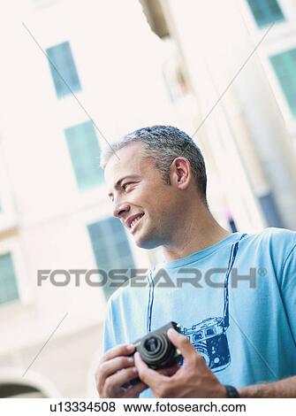 man using camera View Large Photo Image Stock Photo - man using camera. Fotosearch