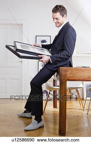 Stock Image - man viewing paintings. Fotosearch