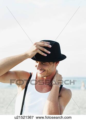 Stock Photo - man wearing hat at beach. Fotosearch