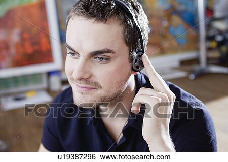 man wearing headphones View Large Photo Image Stock Photograph - man wearing headphones. Fotosearch