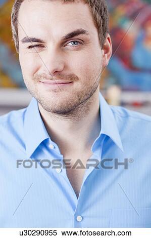 Stock Photography - man winking with one eye. Fotosearch