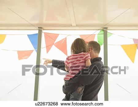 Man with child looking out past bunting View Large Photo Image Stock Photo - Man with child looking out past bunting. Fotosearch