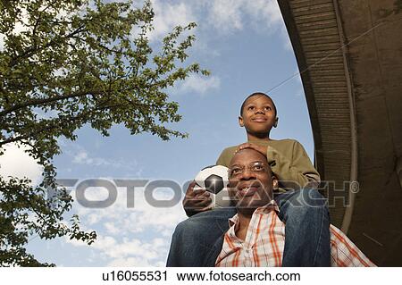 Stock Image - man with child on shoulders. Fotosearch
