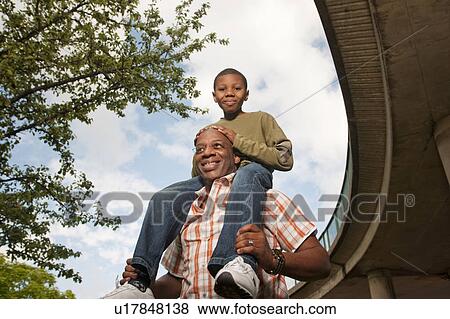 man with child on shoulders View Large Photo Image Stock Photo - man with child on shoulders. Fotosearch