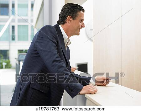 Man with credit card at front desk View Large Photo Image Stock Image - Man with credit card at front desk. Fotosearch