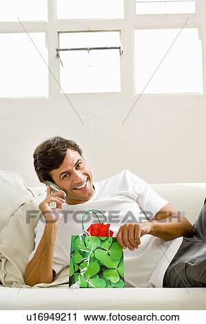 Stock Image - Man with gift bag. Fotosearch