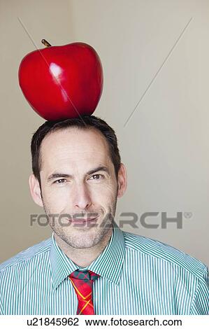 man with oversized apple on his head View Large Photo Image Stock Image - man with oversized apple on his head. Fotosearch
