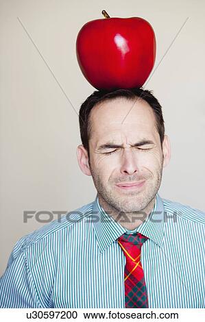 man with oversized apple on his head View Large Photo Image Stock Image - man with oversized apple on his head. Fotosearch