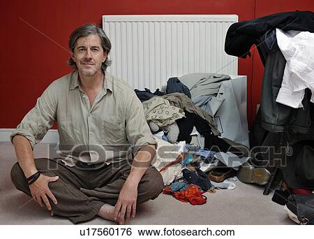 Stock Photograph - man with pile of clothes. Fotosearch