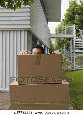Stock Photo - man with stack of boxes. Fotosearch