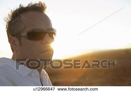 man with sunglasses at sunset View Large Photo Image Stock Photo - man with sunglasses at sunset. Fotosearch