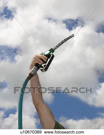 Stock Photo - Mans arm with petrol pump. Fotosearch