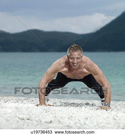 Stock Image - Mature man doing push-up. Fotosearch