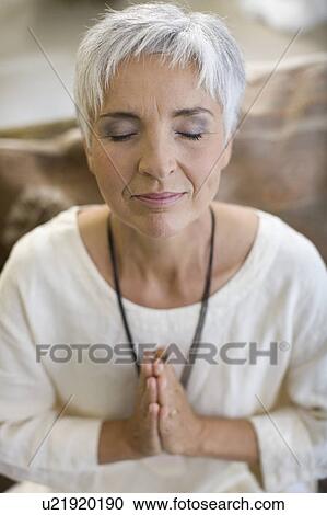 Stock Image - meditating woman. Fotosearch