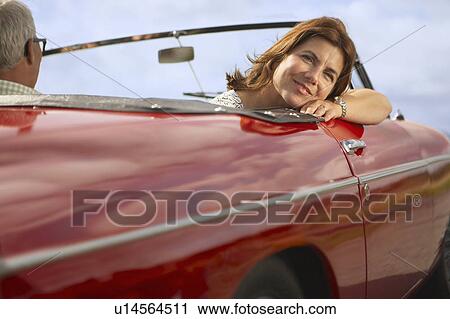 Mid aged couple in sports car View Large Photo Image Stock Image - Mid aged couple in sports car. Fotosearch