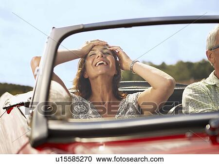 Mid aged Couple in sports car View Large Photo Image Stock Image - Mid aged Couple in sports car. Fotosearch