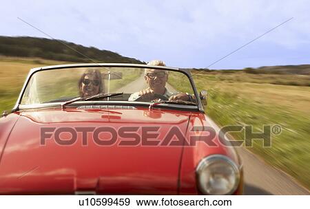Mid aged couple in sports car View Large Photo Image Stock Photo - Mid aged couple in sports car. Fotosearch