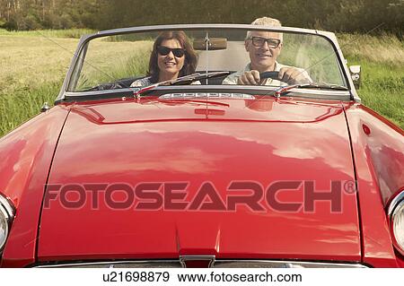 Mid aged couple in sports car View Large Photo Image Stock Photo - Mid aged couple in sports car. Fotosearch