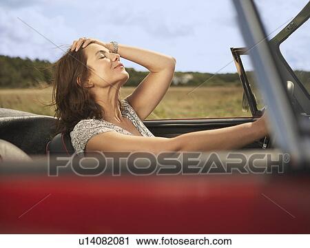 Mid aged woman in sports car View Large Photo Image Stock Image - Mid aged woman in sports car. Fotosearch