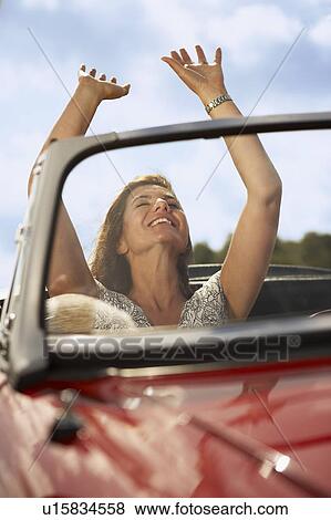 Mid aged woman in sports car View Large Photo Image Stock Photo - Mid aged woman in sports car. Fotosearch