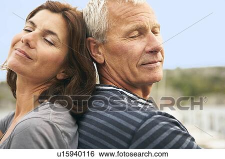 Middle aged couple, back to back View Large Photo Image Stock Photograph - Middle aged couple, back to back. Fotosearch