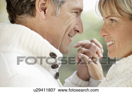 Stock Photo - Middle aged couple holding hands. Fotosearch