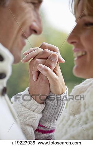 Middle aged couple holding hands View Large Photo Image Stock Photography - Middle aged couple holding hands. Fotosearch