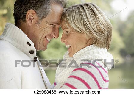 Stock Photo - Middle aged couple hugging. Fotosearch