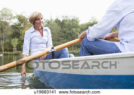 Middle aged couple in a rowboat View Large Photo Image Stock Image - Middle aged couple in a rowboat. Fotosearch