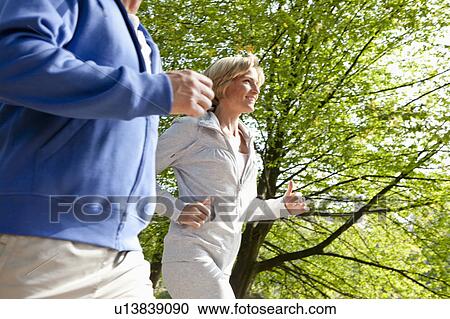 Middle aged couple jogging View Large Photo Image Stock Image - Middle aged couple jogging. Fotosearch