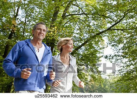 Middle aged couple jogging View Large Photo Image Stock Image - Middle aged couple jogging. Fotosearch