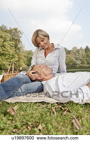 Middle aged couple on a picnic blanket View Large Photo Image Stock Image - Middle aged couple on a picnic blanket. Fotosearch