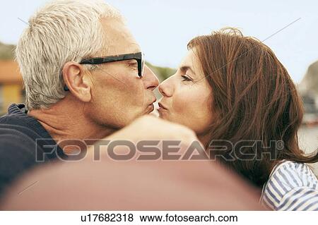 Stock Photo - Middle aged couple on an old boat. Fotosearch
