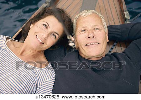 Stock Photograph - Middle aged couple on boat (portrait). Fotosearch