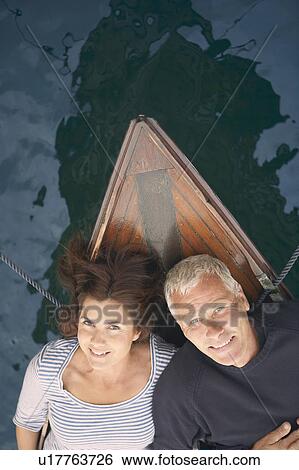 Stock Photograph - Middle aged couple on boat (portrait). Fotosearch