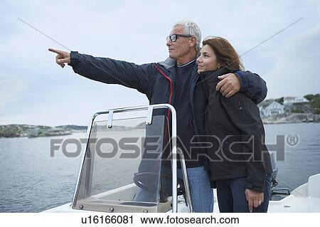 Middle aged couple on motor boat View Large Photo Image Stock Image - Middle aged couple on motor boat. Fotosearch