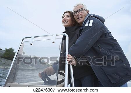 Middle aged couple on motor boat View Large Photo Image Stock Photo - Middle aged couple on motor boat. Fotosearch