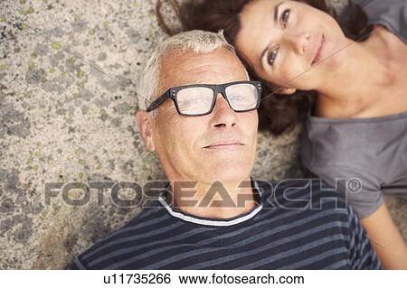 Middle aged couple on rocks portrait View Large Photo Image Stock Photograph - Middle aged couple on rocks portrait. Fotosearch