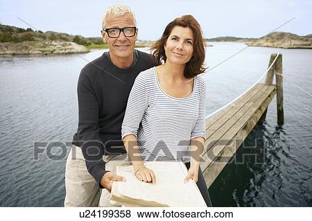 Middle aged couple with map View Large Photo Image Stock Photo - Middle aged couple with map. Fotosearch
