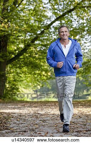 Middle aged man jogging View Large Photo Image Stock Photo - Middle aged man jogging. Fotosearch