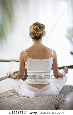Picture - middle-aged woman doing yoga. Fotosearch