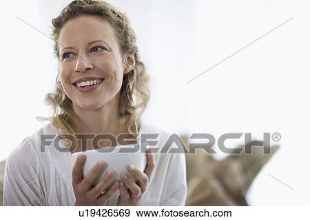 Stock Photo - middle-aged woman drinking tea. Fotosearch
