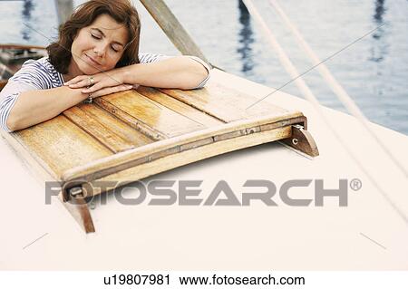 Middle aged woman on old boat View Large Photo Image Stock Image - Middle aged woman on old boat. Fotosearch