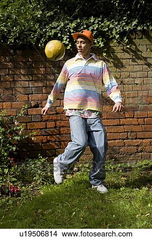 Mixed Race Teenager playing Football View Large Photo Image Picture - Mixed Race Teenager playing Football. Fotosearch