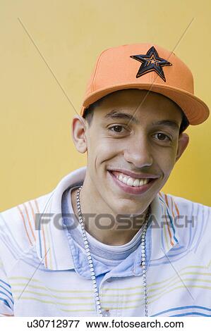 Stock Photo - Mixed race Teenager with cap and chain. Fotosearch