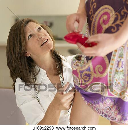 mother adjusting hem for daughter View Large Photo Image Stock Image - mother adjusting hem for daughter. Fotosearch