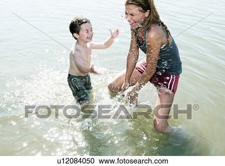 Stock Image - mother and child splashing in river. Fotosearch
